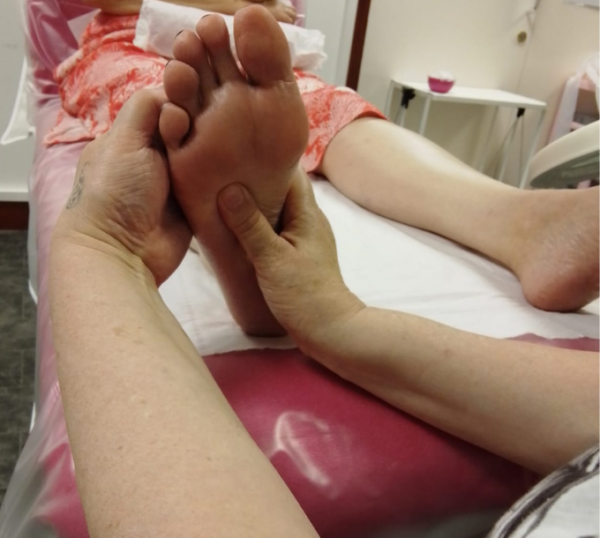 Reflexology foot treatment in a training room