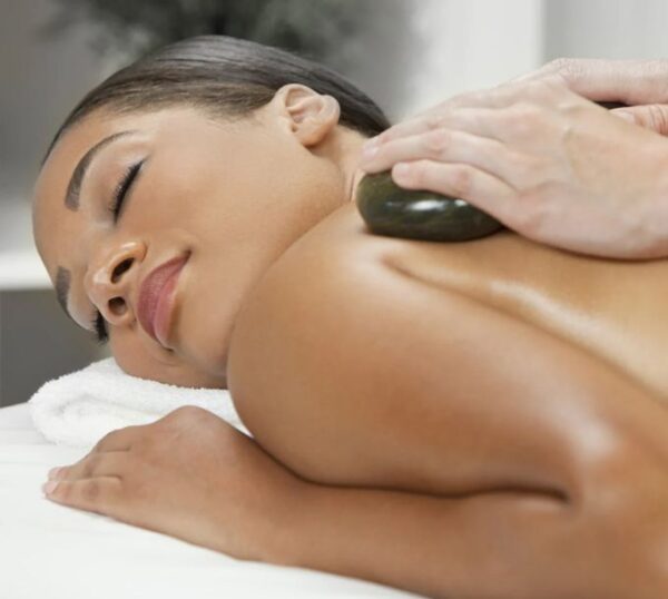 Client relaxing during a hot stone massage