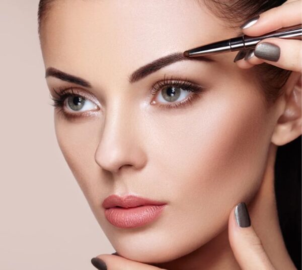 Brow being shaped with tweezers for a high definition brow