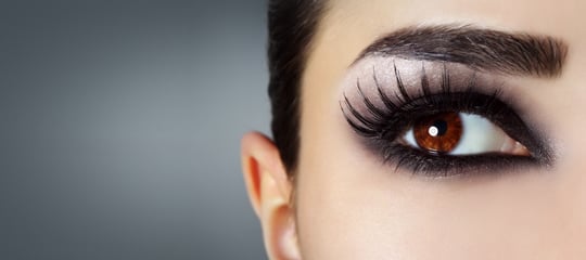Close-up of a defined brow and dramatic eye make-up