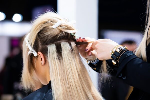Tape hair extensions being fitted