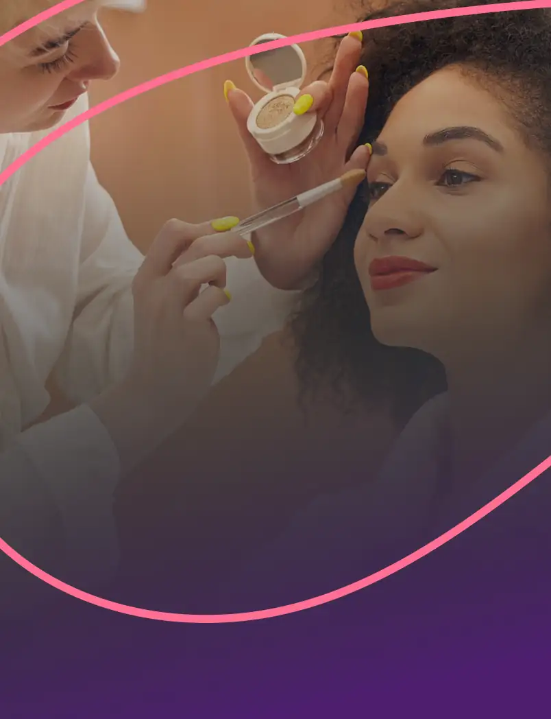 Make-up artist applying eyeshadow to a client